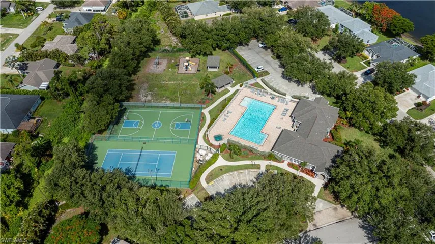 Aerial view of property and surrounding area with nearby suburban area