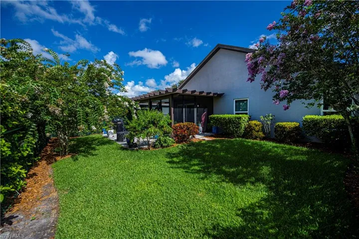View of green lawn with a sunroom