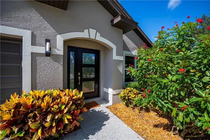 Property entrance featuring stucco siding