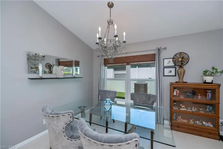Dining space with a chandelier and lofted ceiling