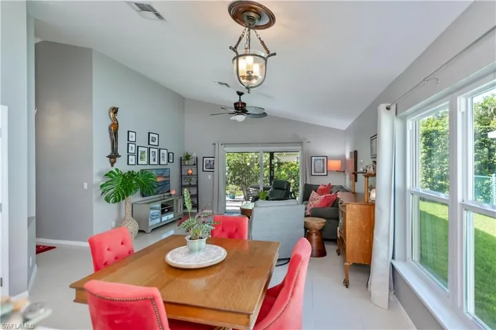 Dining room with lofted ceiling, plenty of natural light, and ceiling fan