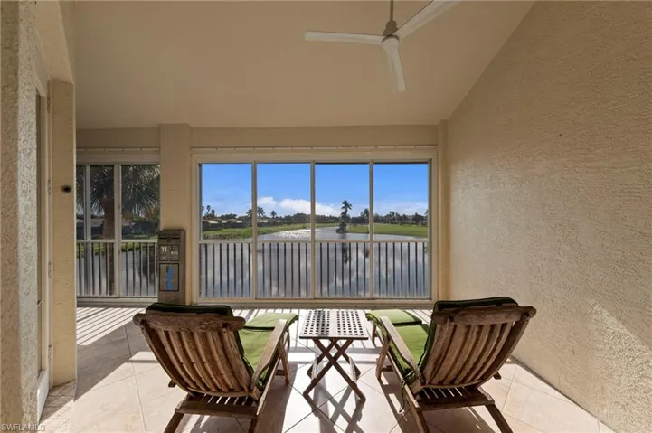 Screened patio with tiled flooring and a ceiling fan