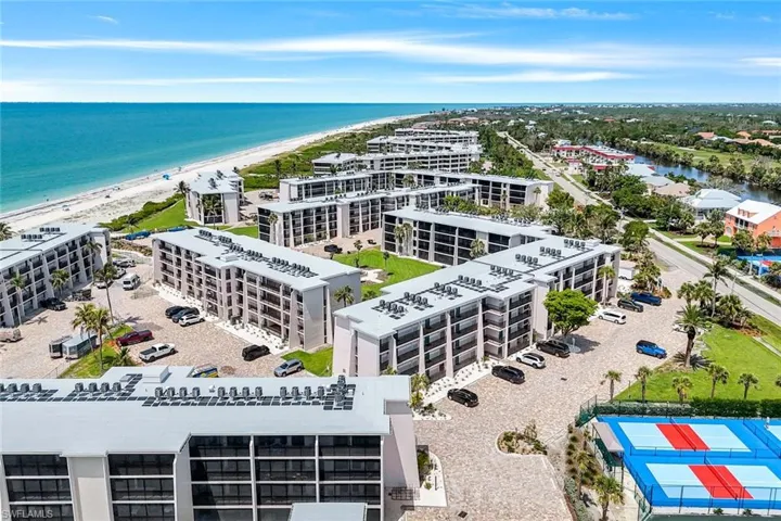 Drone / aerial view of expansive coastline and apartment complex / building