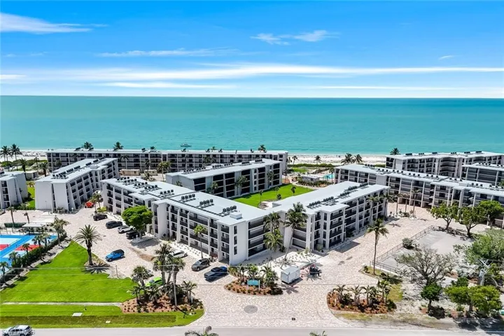 Drone / aerial view of a large body of water and apartment complex