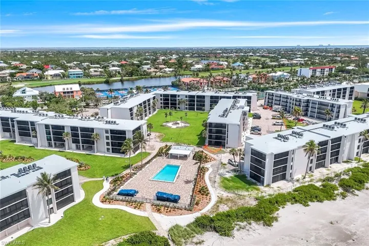 Bird's eye view of a nearby body of water and a pool area