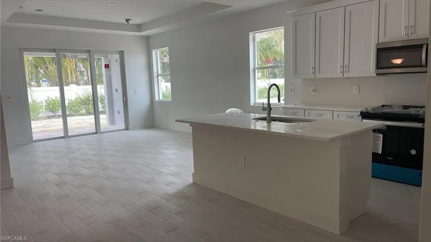 View of kitchen and great room with tray ceiling