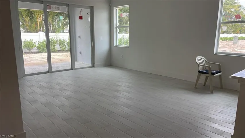 Great room with tray ceiling and copious amounts of natural light