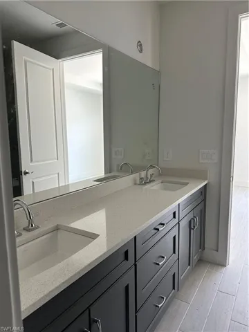 Bathroom featuring double sink vanity and hardwood / wood-style floors