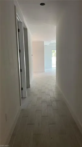 Foyer front entrance with additional bedroom (on left) and lead-in to kitchen and great room (on right)