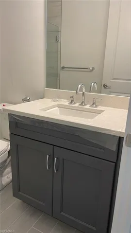 Guest bathroom with quartz countertops and soft-close cabinets