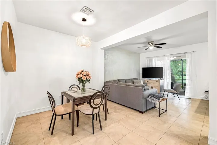 Dining space featuring light tile patterned floors and ceiling fan