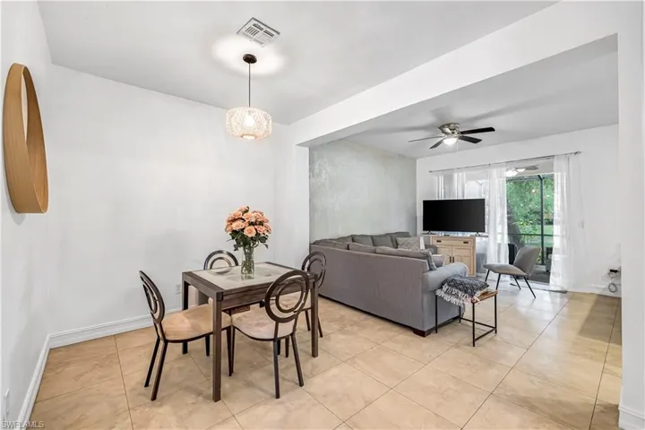 Dining area with light tile patterned floors and ceiling fan