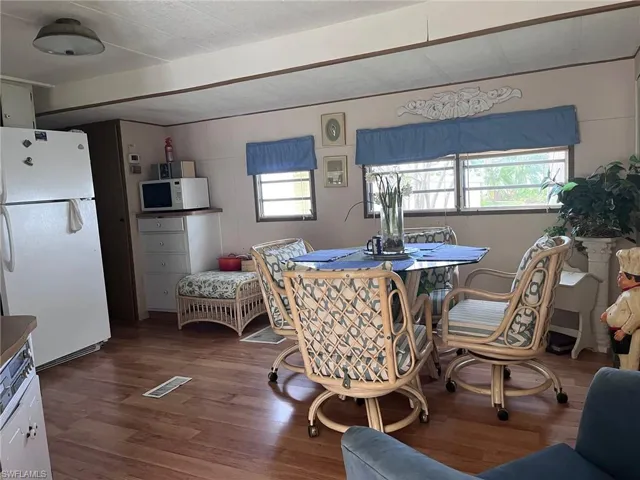 Dining area with hardwood / wood-style floors and a healthy amount of sunlight