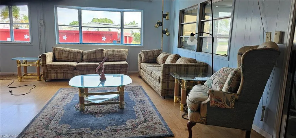Living room with light wood-type flooring and plenty of natural light
