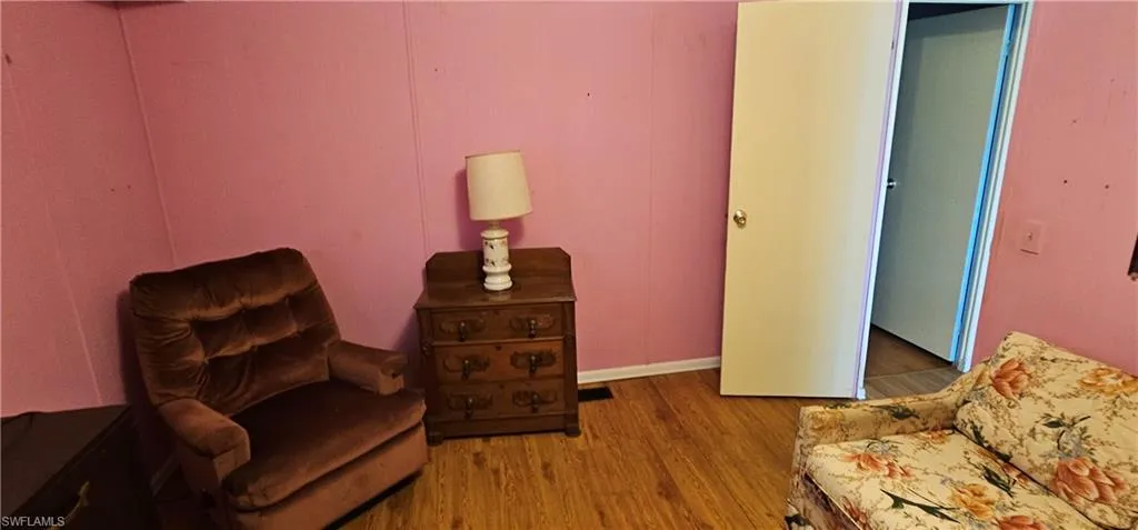 Living area with hardwood / wood-style floors