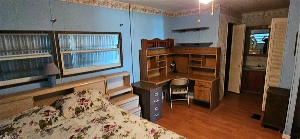 Home office with wood-type flooring