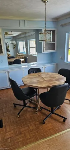 Dining area featuring dark parquet flooring