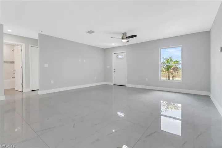 Unfurnished room featuring light marble finish flooring, baseboards, a ceiling fan, and recessed lighting