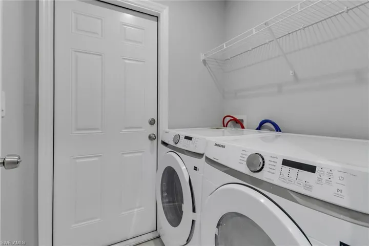 Clothes washing area featuring washing machine and dryer