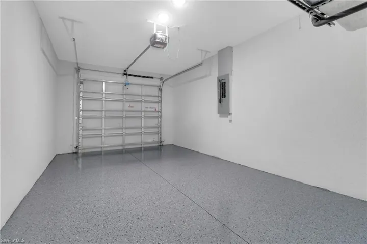 Garage with a garage door opener and electric panel