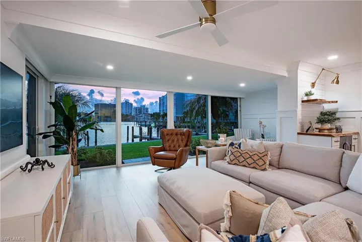 Living room with ceiling fan and light wood-type flooring