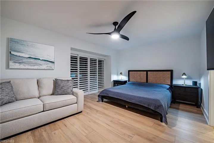 Upper guest bedroom featuring ceiling fan and light wood-type flooring