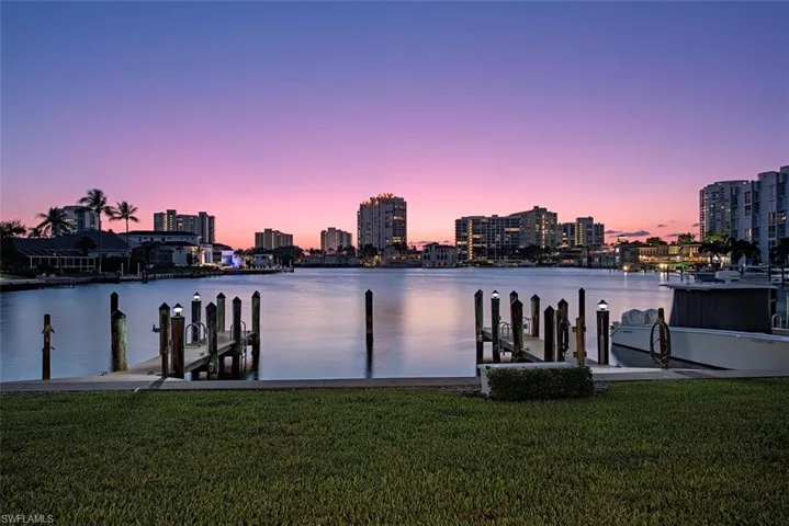 Dock area featuring a lawn and a water view