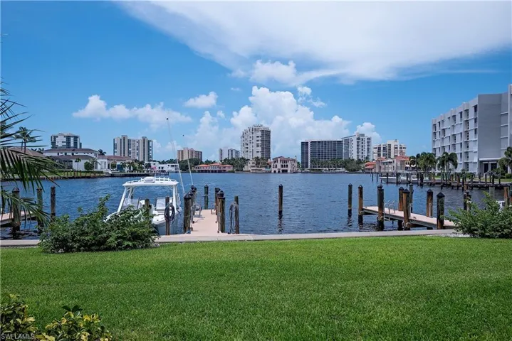 View of dock featuring a water view and a lawn
