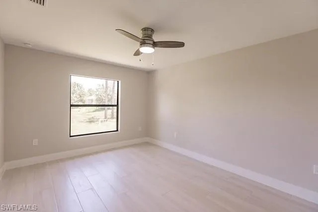 Unfurnished room with light hardwood / wood-style flooring and ceiling fan