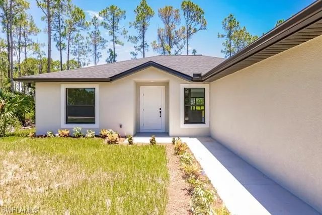 Property entrance with a lawn