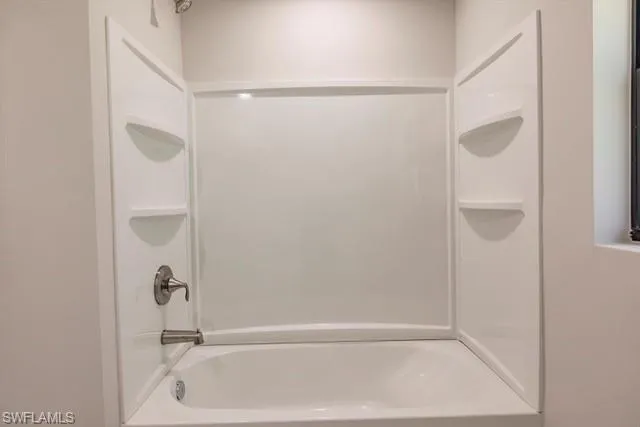 Bathroom with shower / washtub combination