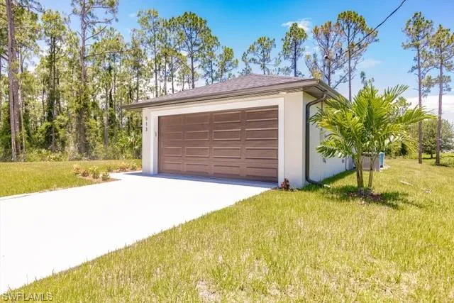 Garage featuring a yard