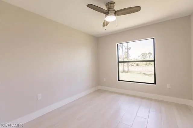Unfurnished room with light hardwood / wood-style floors, plenty of natural light, and ceiling fan