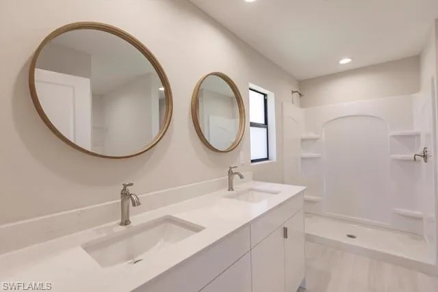 Bathroom featuring vanity and walk in shower