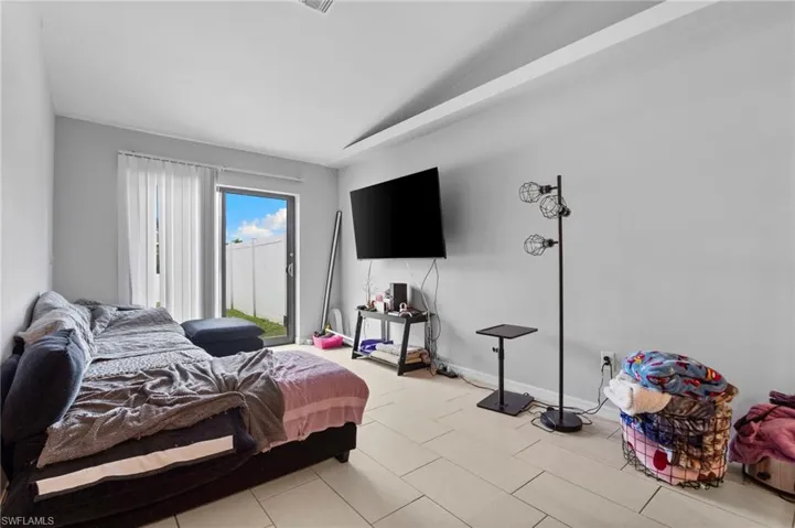 Bedroom featuring vaulted ceiling and baseboards