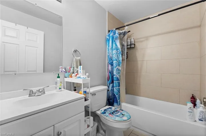 Full bath with vanity and shower / tub combo with curtain
