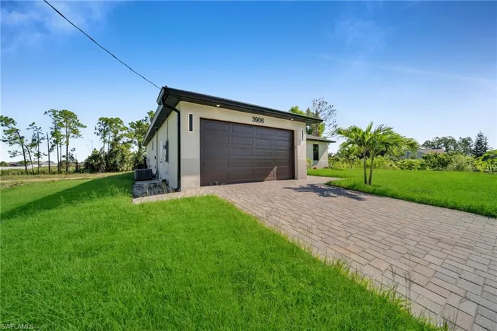 Garage featuring decorative driveway