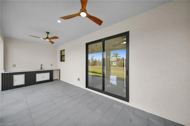 View of patio featuring a ceiling fan