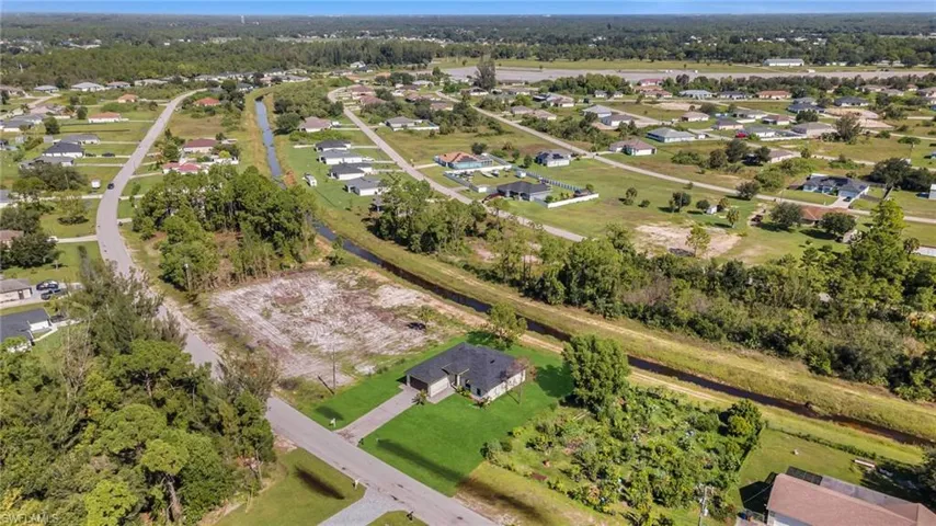 Aerial overview of property's location with nearby suburban area