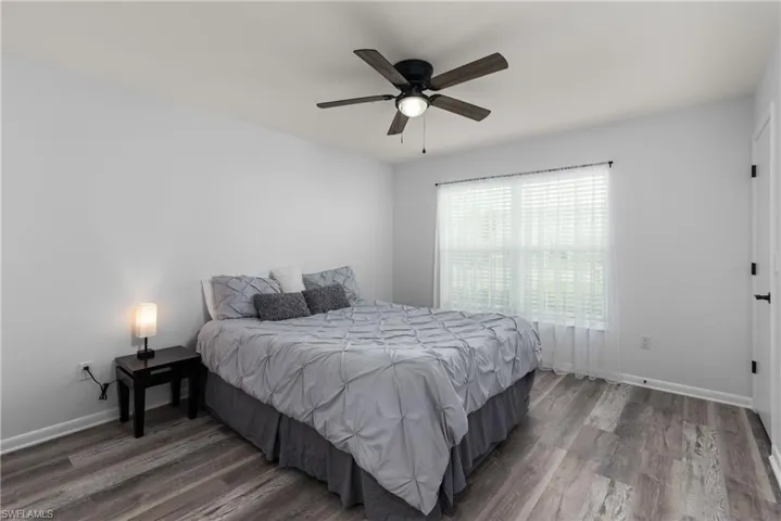 Bedroom featuring wood finished floors and a ceiling fan