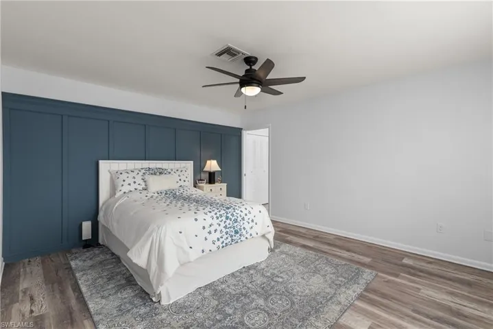 Bedroom with wood finished floors and a ceiling fan