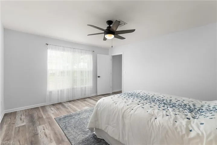 Bedroom with wood finished floors and a ceiling fan
