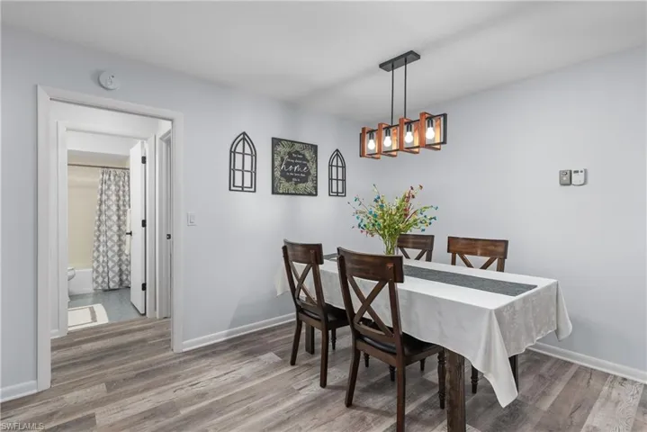 Dining room with light wood-style flooring and baseboards