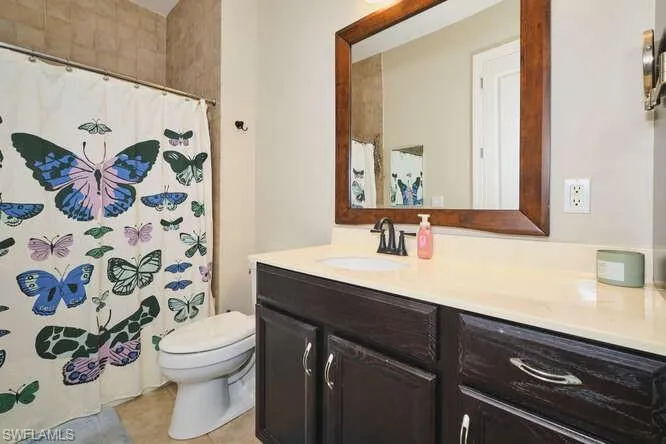 Full bathroom featuring vanity and a shower with shower curtain
