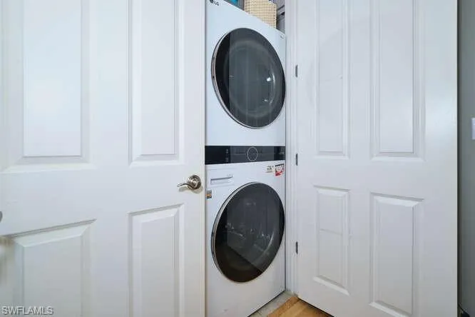 Laundry area with stacked washer and dryer