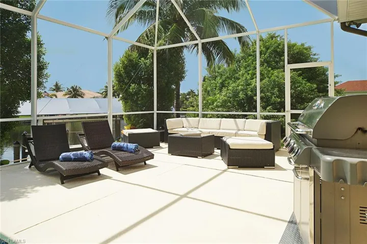 Sunroom with an outdoor hangout area and a wall of windows