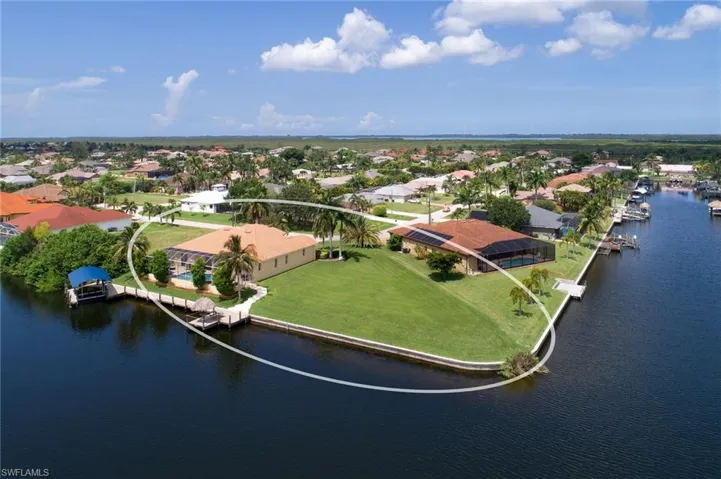 Aerial perspective of suburban area featuring a large body of water