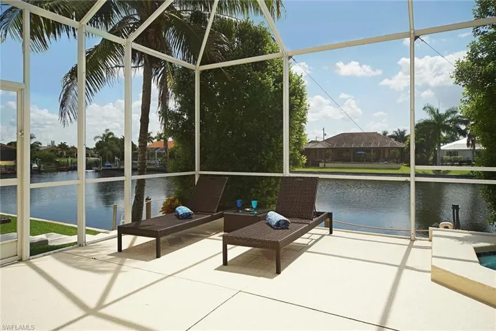 Sunroom featuring a water view