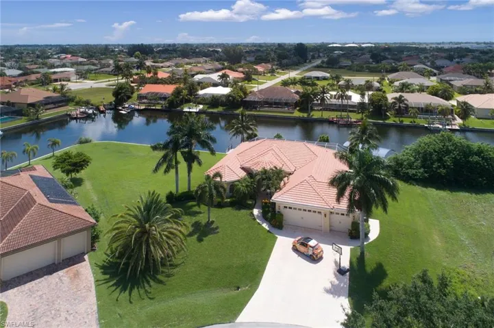 Aerial perspective of suburban area featuring a nearby body of water