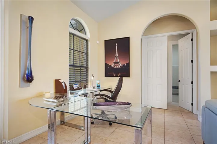 Office space with baseboards and light tile patterned flooring